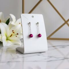 Pembe Kaplan Gözü Taşlı Zincir Küpe – Güç, Denge ve Zarafet